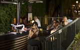 A woman and a man enjoy a glass of wine in the outdoor bar Josefa Karree.