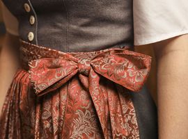 Dirndl bow in red on a work uniform at the Platzl Hotel Munich